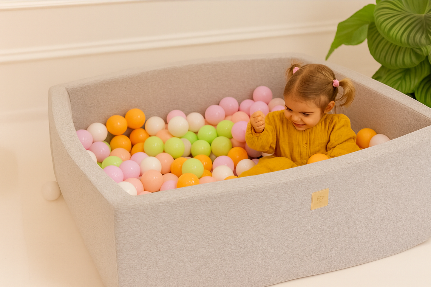 Child playing with colorful ball pit inside a storage unit.